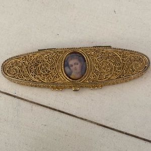 Estée Lauder oval compact with womans’ face on front,